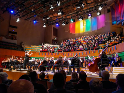 Hundreds of singers and an orchestra performing at the Hand in Hand LGBT+ choral festival in Cardiff's St David's Hall